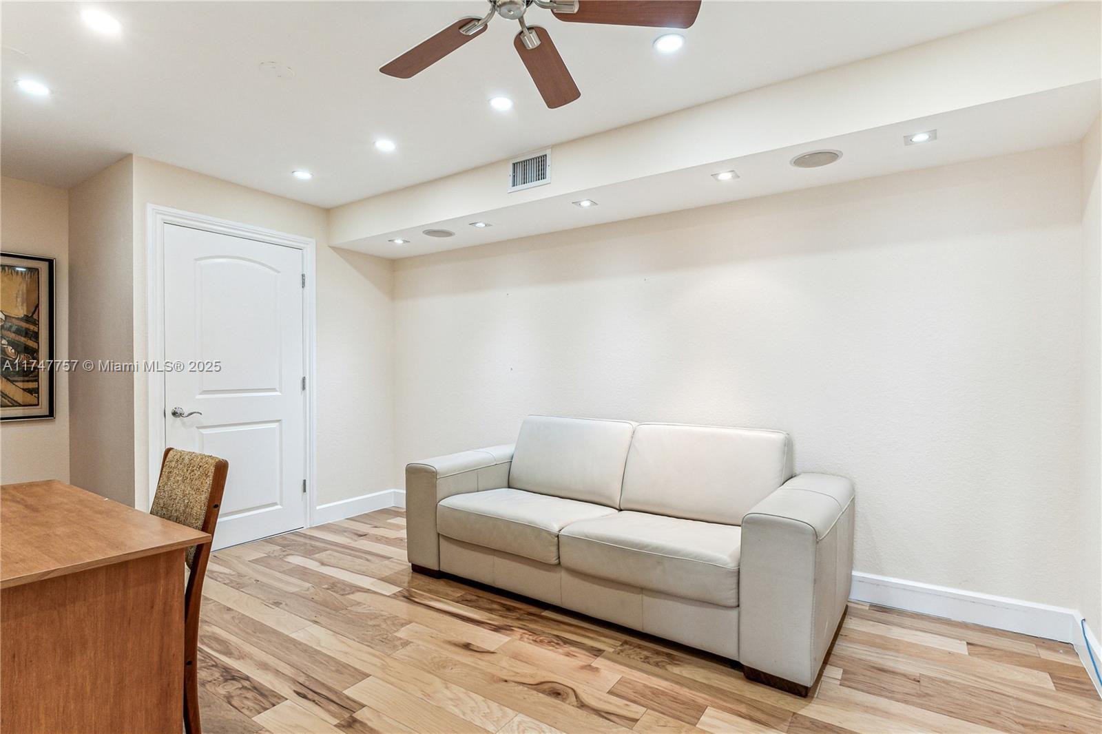 4000 Towerside Terrace, Unit TS3 Miami, FL 33138 - Photo 18 of 49 a living room with furniture and a wooden floor
