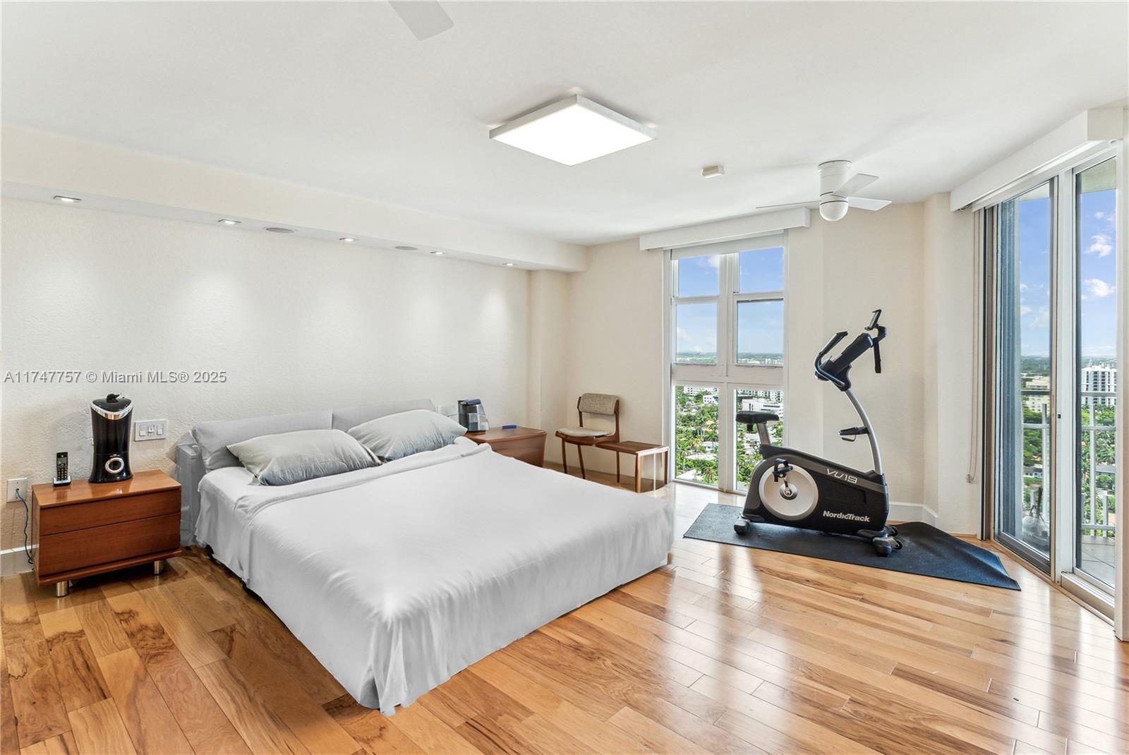 4000 Towerside Terrace, Unit TS3 Miami, FL 33138 - Photo 22 of 49 a bedroom with a bed and wooden floor