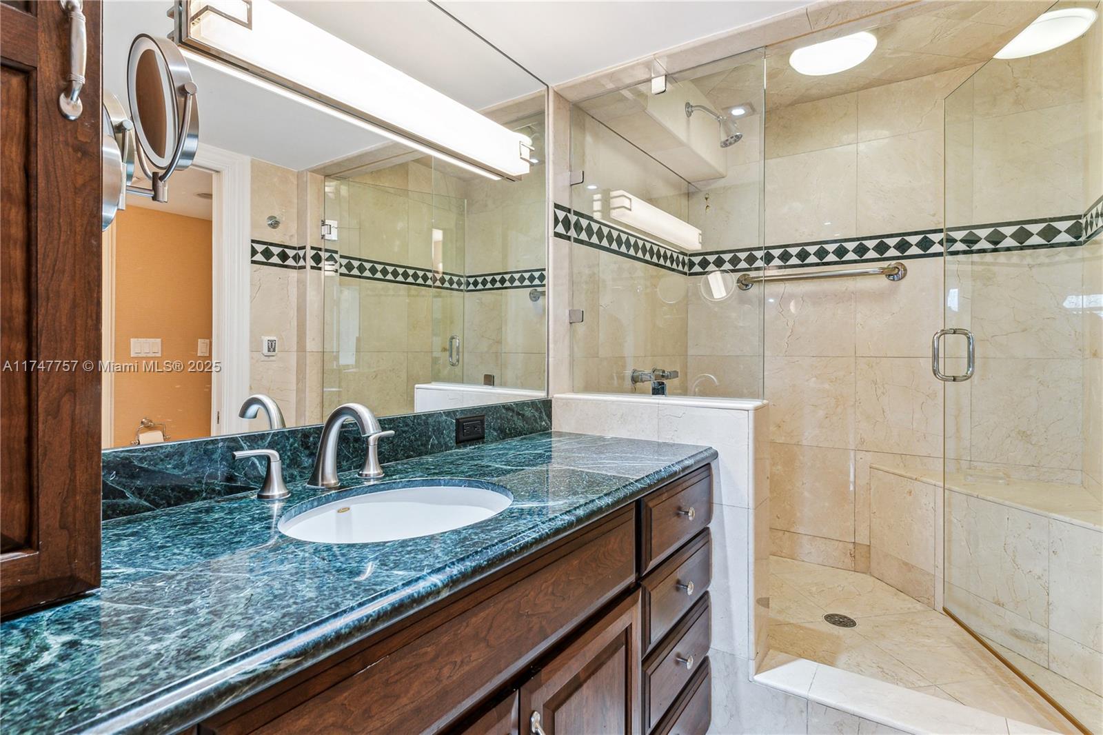 4000 Towerside Terrace, Unit TS3 Miami, FL 33138 - Photo 30 of 49 a bathroom with a granite countertop sink a mirror a glass door shower and vanity