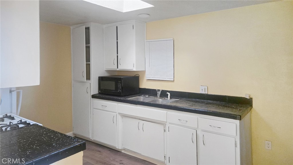 118 West Wilson Avenue Ridgecrest, CA 93555 - Photo 8 of 8 a bathroom with a granite countertop sink and a mirror