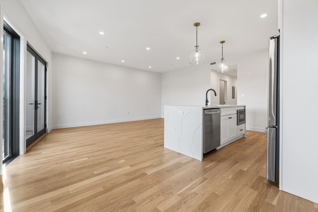 268 Bremen Street, Unit 2 Boston, MA 02128 - Photo 5 of 8 a view of a kitchen with wooden floor