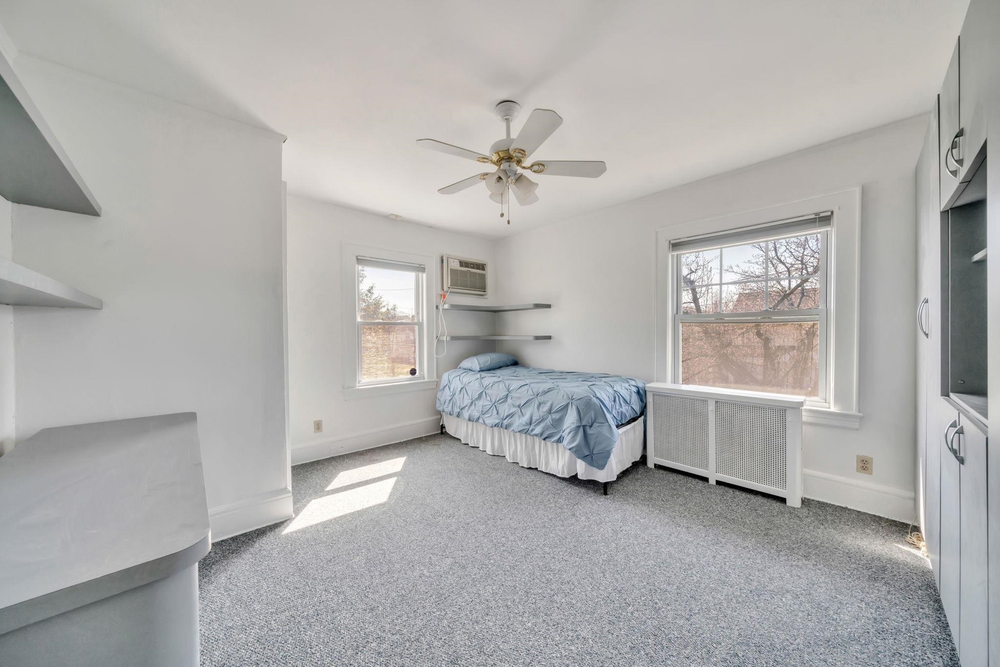 865 Livingston Road Elizabeth, NJ 07208 - Photo 28 of 39 a bedroom with a bed and a window