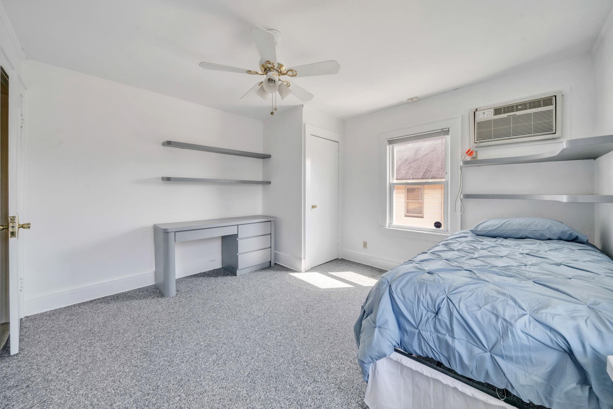 865 Livingston Road Elizabeth, NJ 07208 - Photo 30 of 39 a bedroom with a bed and a chandelier