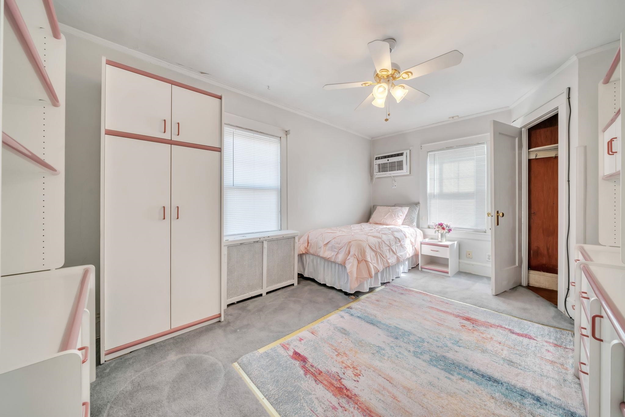 865 Livingston Road Elizabeth, NJ 07208 - Photo 32 of 39 a bedroom with a large bed and a chandelier