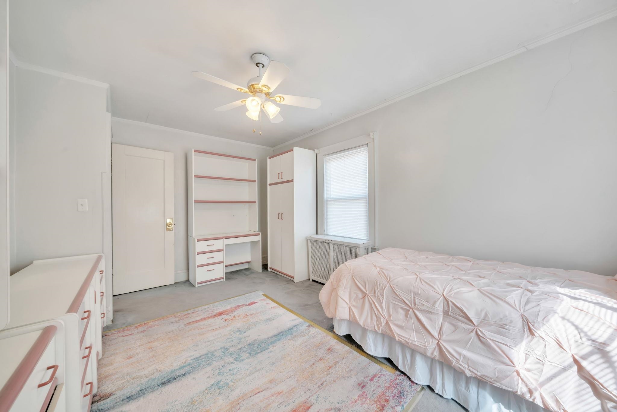 865 Livingston Road Elizabeth, NJ 07208 - Photo 33 of 39 a bedroom with a bed and a chandelier