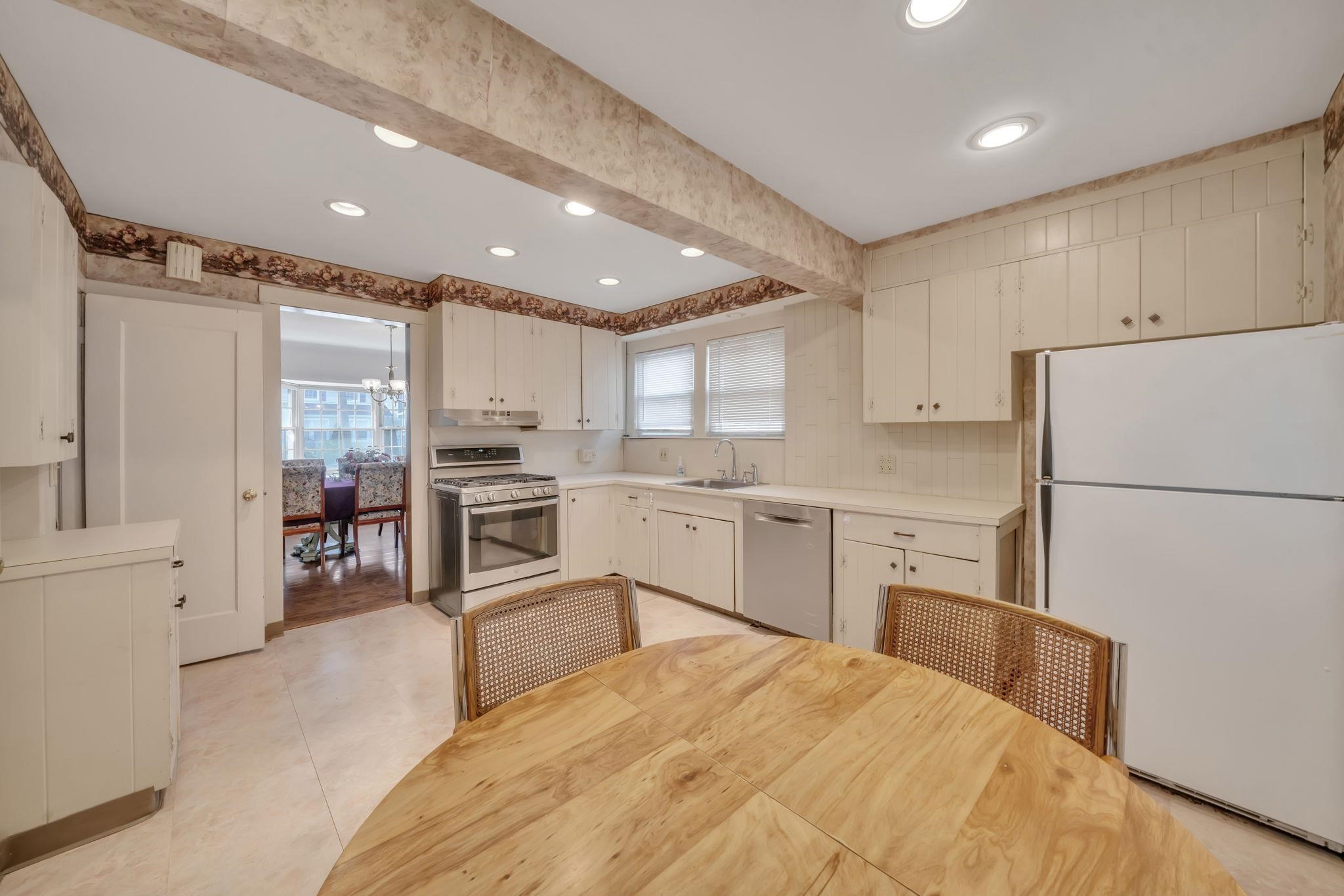 865 Livingston Road Elizabeth, NJ 07208 - Photo 7 of 39 a kitchen with white cabinets and stainless steel appliances