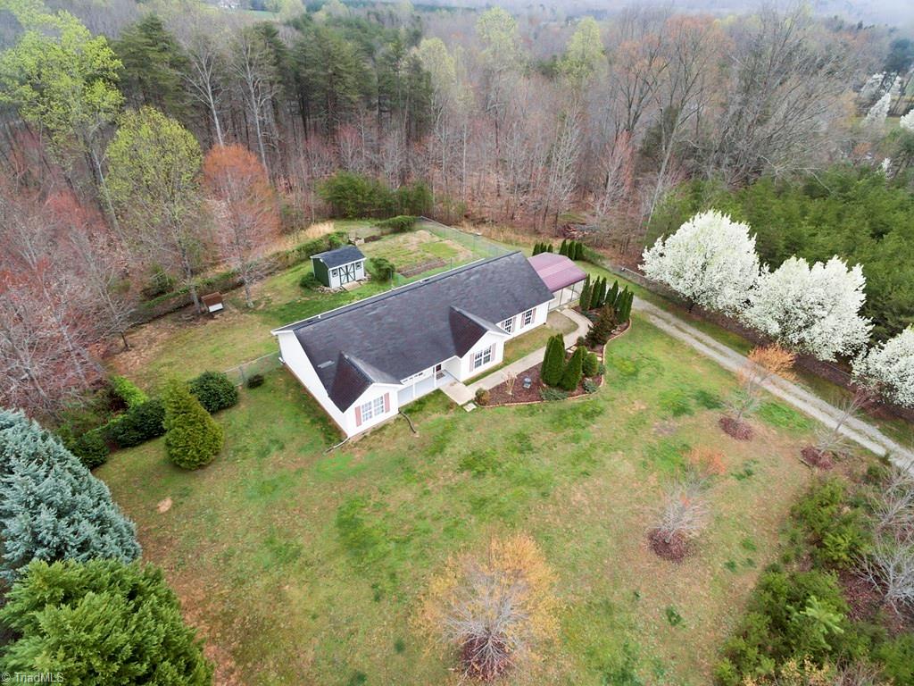 8124 Shoeline Road Stokesdale, NC 27357 - Photo 25 of 29 Aerial view or the home with all the mature trees.