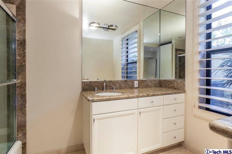 2190 Kinneloa Canyon Road Pasadena, CA 91107 - Photo 14 of 24 a bathroom with a granite countertop sink and a mirror