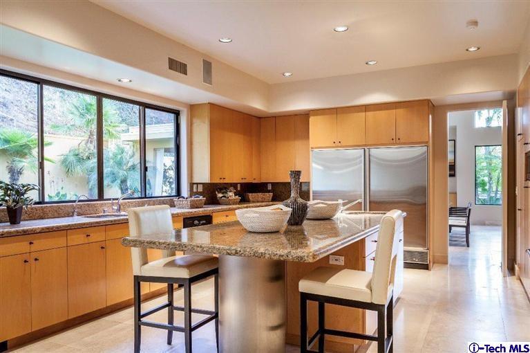 2190 Kinneloa Canyon Road Pasadena, CA 91107 - Photo 8 of 24 a dining room with stainless steel appliances granite countertop a stove top oven a dining table and chairs