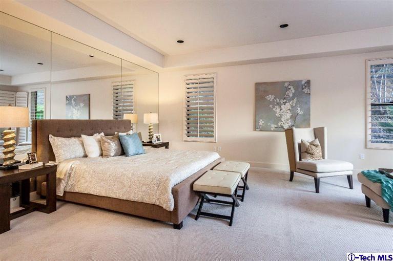 2190 Kinneloa Canyon Road Pasadena, CA 91107 - Photo 9 of 24 a spacious bedroom with a bed a table and chair