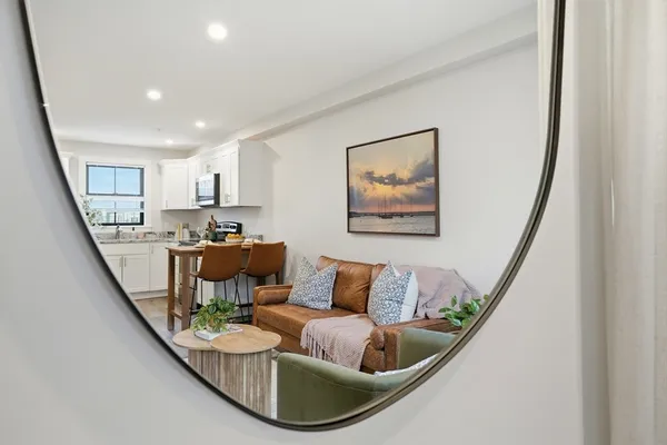 a living room with furniture and a painting
