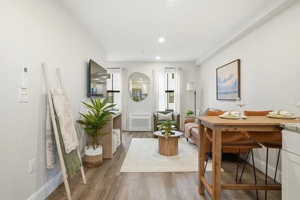 a view of a dining room with furniture and wooden floor