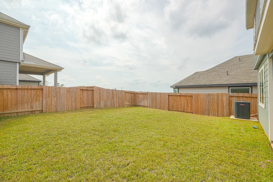 9219 Grace Rdg Drive Willis, TX 77318 - Photo 35 of 36 a view of a yard with wooden fence