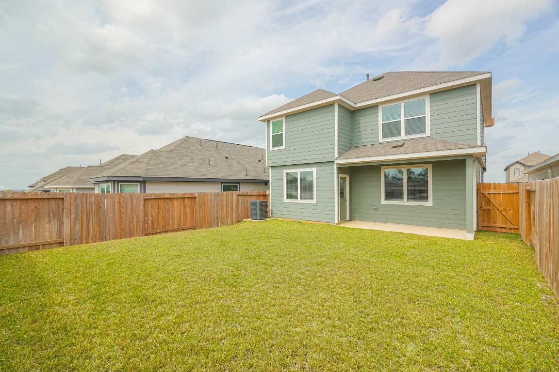 9219 Grace Rdg Drive Willis, TX 77318 - Photo 36 of 36 a view of a house with a swimming pool and a yard