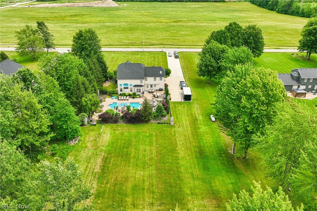 8874 Sharp Road Olmsted Falls, OH 44138 - Photo 3 of 42 Expansive property featuring a large residence with multiple gables, an inground swimming pool, and a lengthy paved driveway