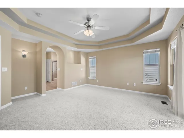a view of a livingroom with a ceiling fan and window