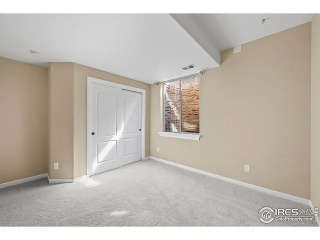 a living room with furniture and floor to ceiling windows