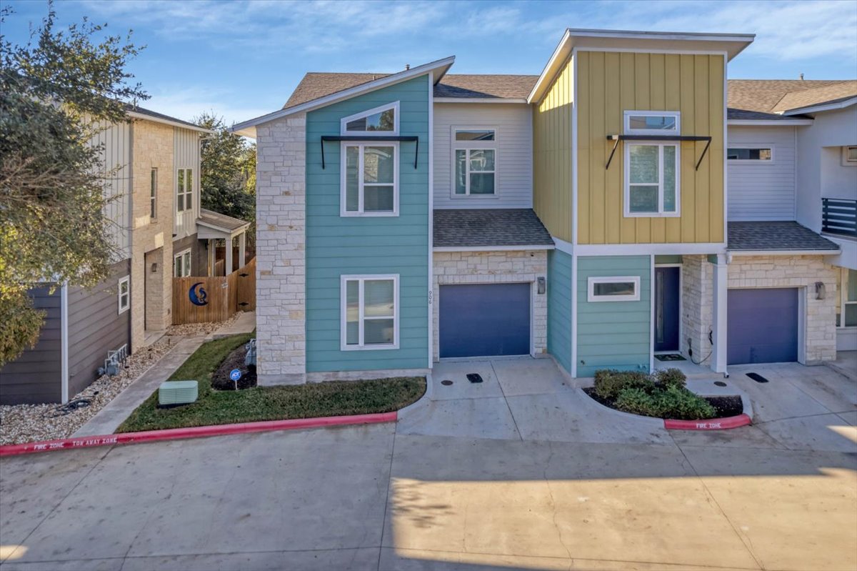 8922 Manchaca Road, Unit 906 Austin, TX 78748 - Photo 27 of 29 a front view of a house with a yard and garage