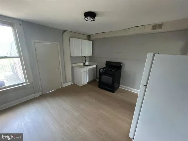 a view of kitchen with furniture and wooden floor