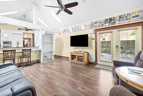 a white kitchen with a table and chairs in it