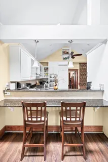 a view of a workspace with furniture and a window
