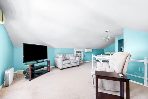 a bedroom with a bed and a refrigerator