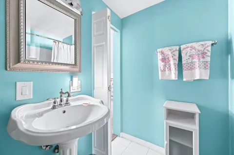 a view of a chair and table in backyard of the house