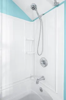 a view of a patio with table and chairs potted plants and floor to ceiling window