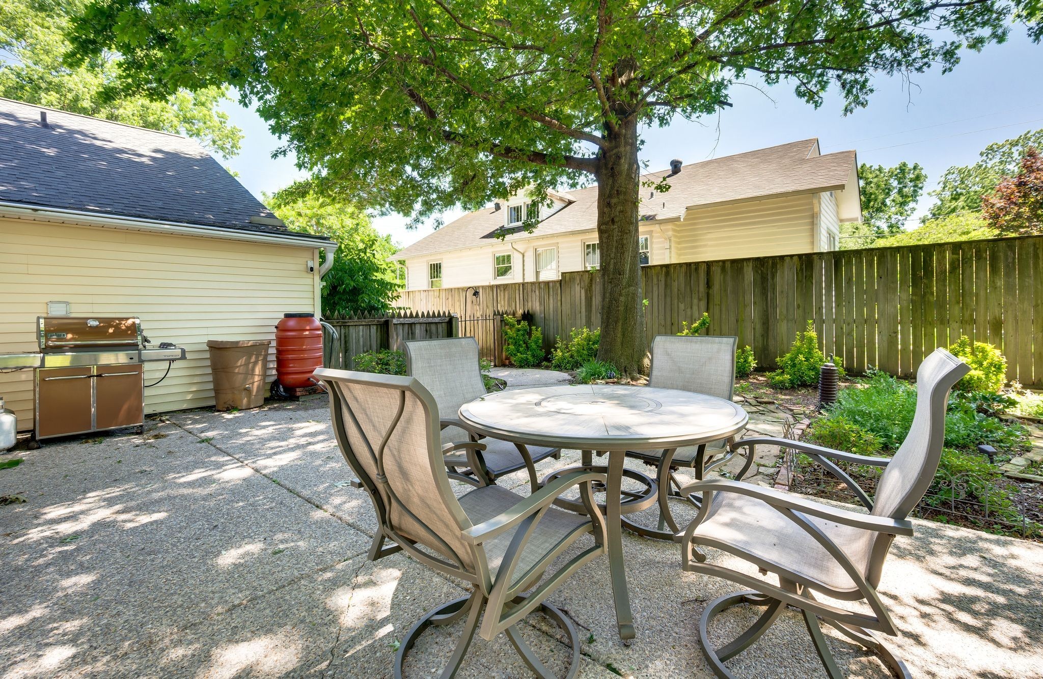 802 North 16th Street Nashville, TN 37206 - Photo 40 of 44 a view of a patio with table and chairs potted plants and a palm tree