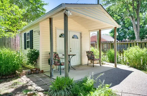 a view of a house with backyard and sitting area