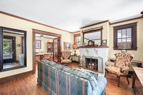a living room with furniture and a floor to ceiling window