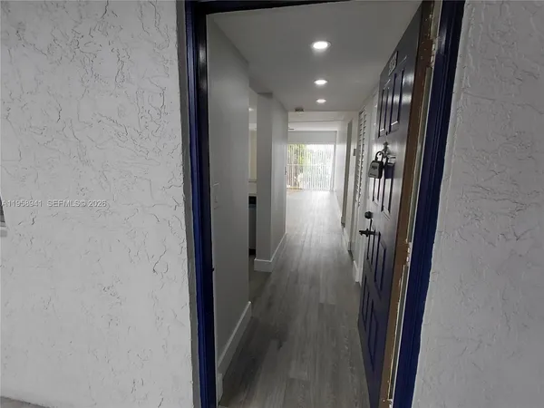 a kitchen with a refrigerator and a stove top oven