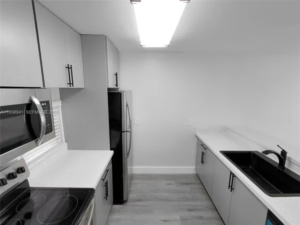 a kitchen with a stove and a microwave