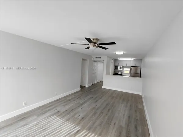 a view of a hallway with wooden floor
