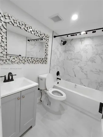 a bathroom with a sink a toilet and a bathtub