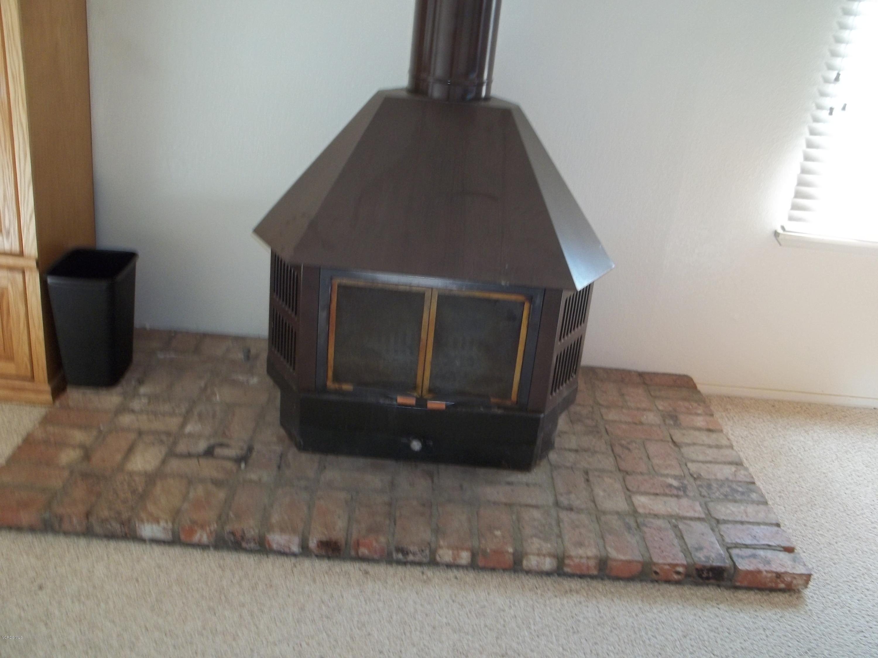 19370 Water Canyon Road Tehachapi, CA 93561 - Photo 16 of 38 a living room with a fireplace