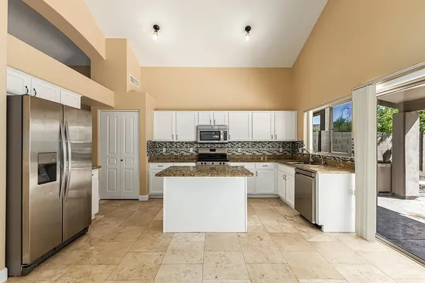 a kitchen with a refrigerator and a sink