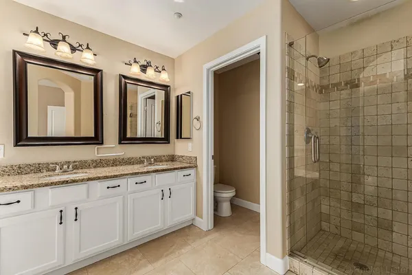 a bathroom with a double vanity sink and a mirror