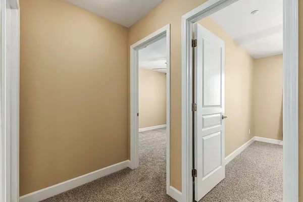 a view of a hallway with two rooms