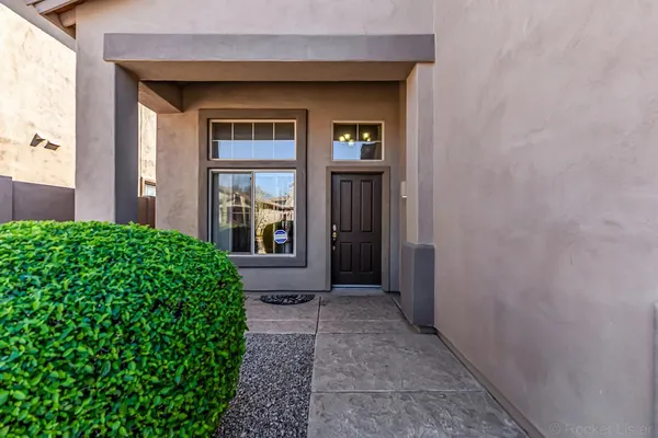 a view of a front door of a house with a yard