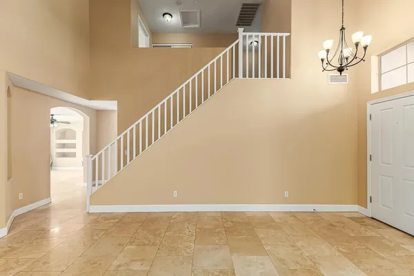 a view of staircase with white walls and a window