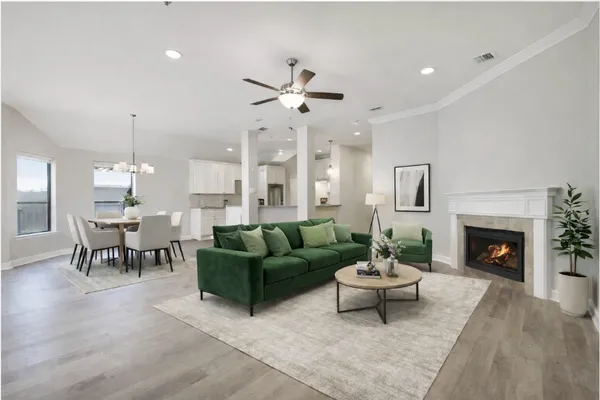 an empty room with windows and fireplace