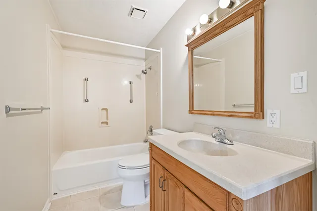 a bathroom with a sink toilet vanity and shower