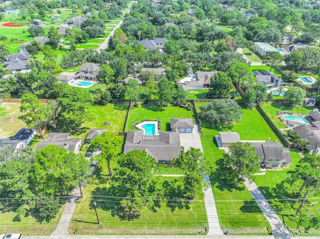an aerial view of residential houses with outdoor space