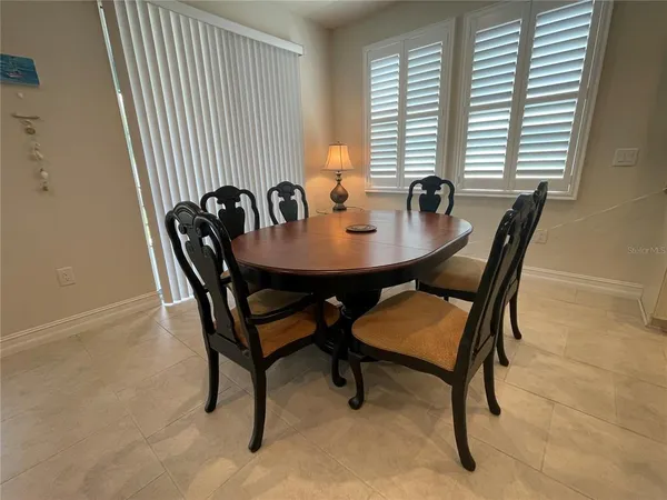 a view of a dining room with furniture and window