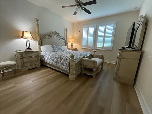 a bedroom with a bed window and a dresser