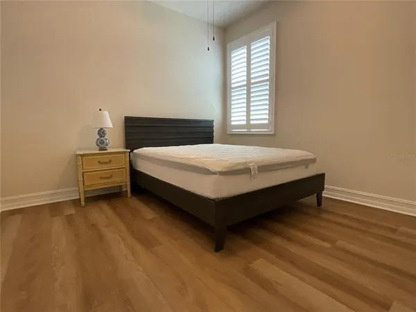 a bedroom with a bed and window