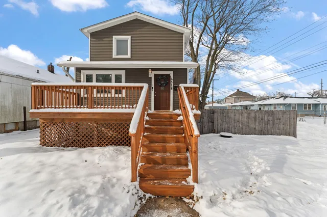 a view of a brick house with large windows and a table