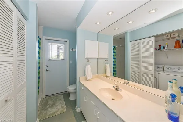 a bathroom with a tub sink and a mirror