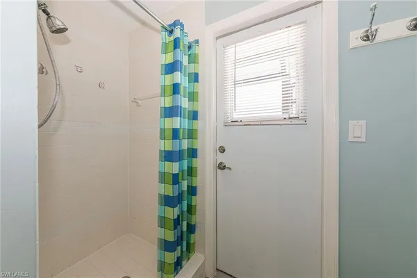 a bathroom with a shower and a window